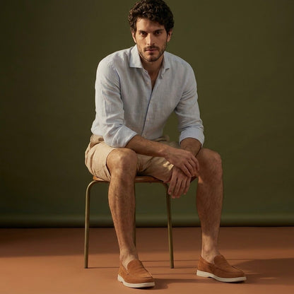Anzio Loafer Caramel, worn with linen, on a stool