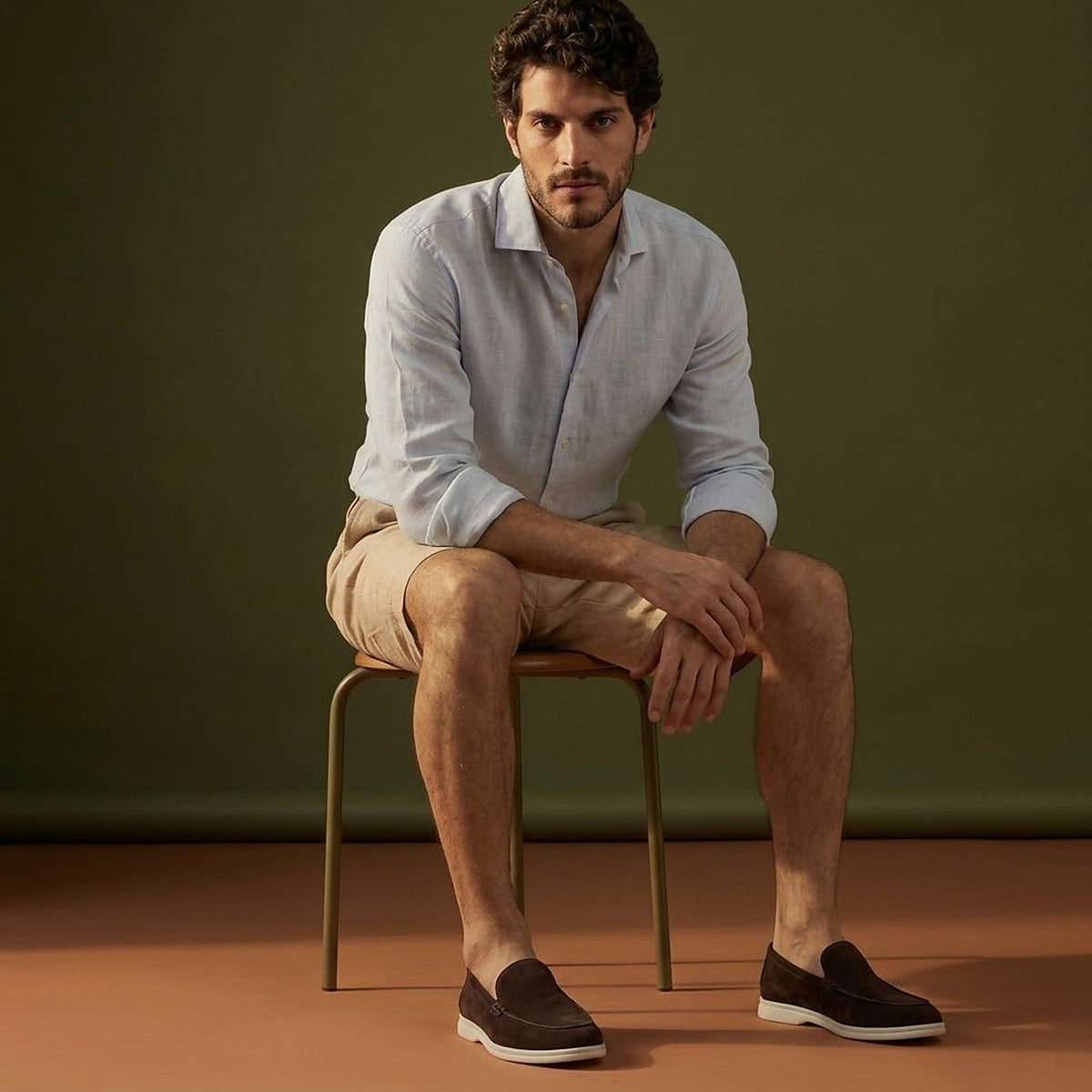 Anzio Loafer Coffee, worn with linen, on a stool