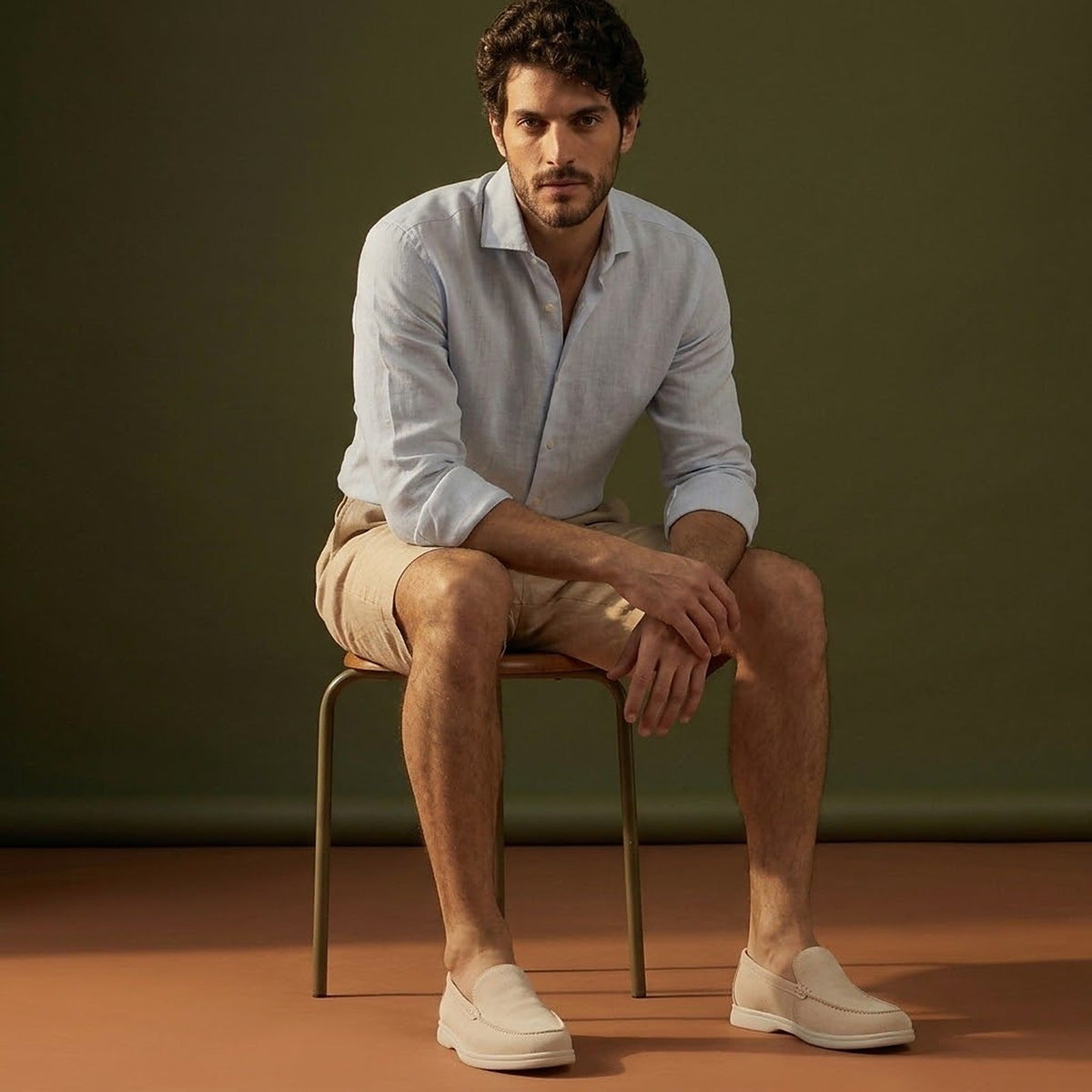 Anzio Loafer Ivory, worn with linen, on a stool