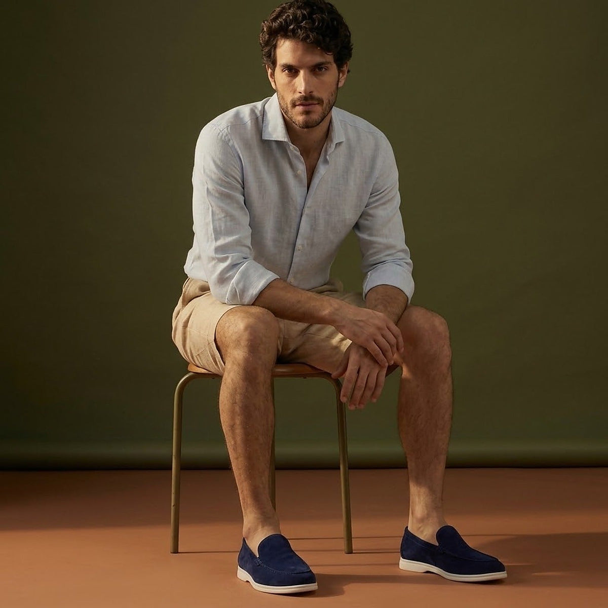 Anzio Loafer Navy, worn with linen, on a stool