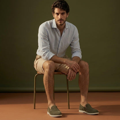 Anzio Loafer Olive, worn with linen, on a stool