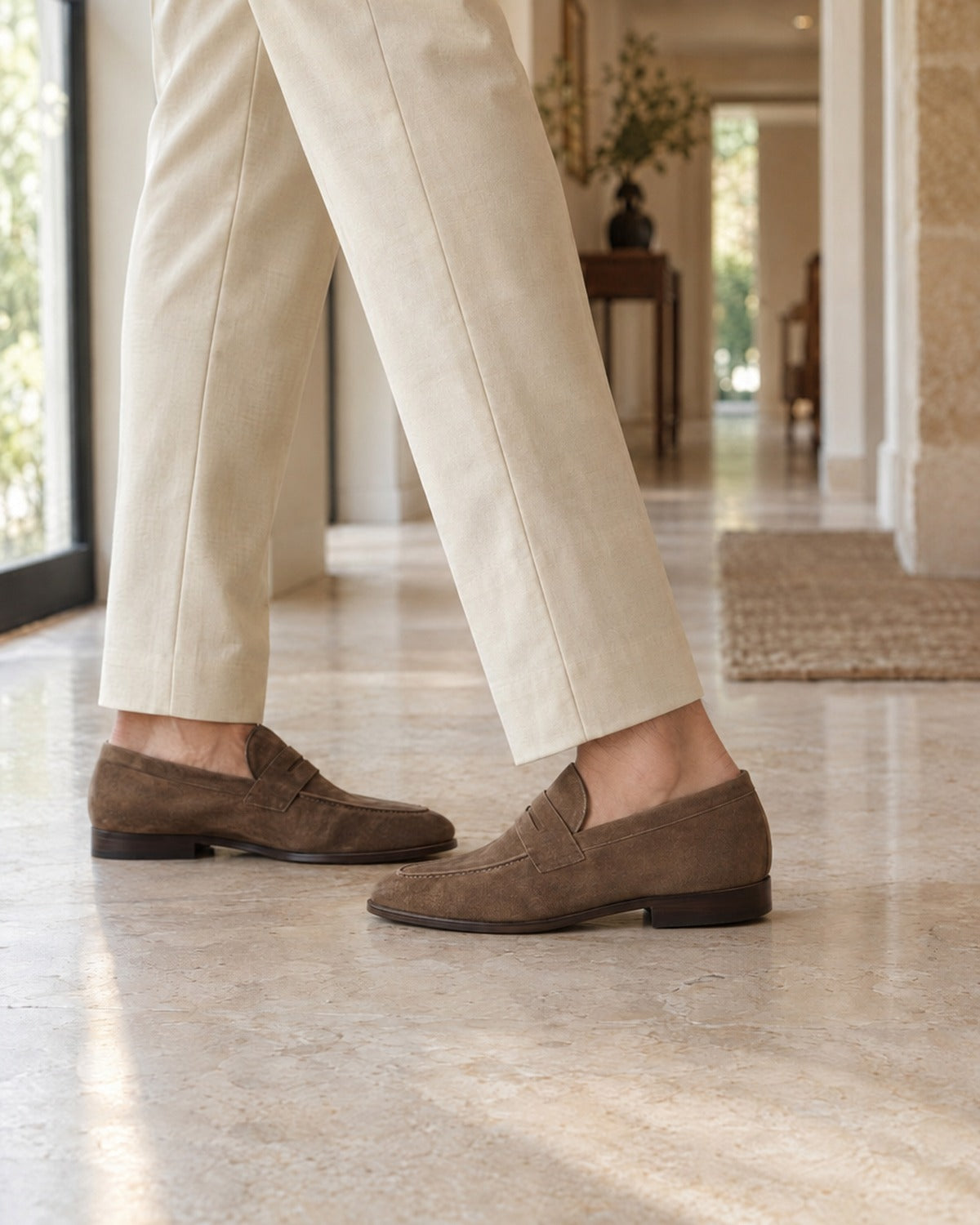 Suede penny loafers on a marble floor